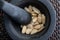 Close-up with almonds nuts. In stone mortar.