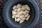 Close-up with almonds nuts. In stone mortar.