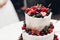 Close-up amazing fresh appetizing sweet cake with cream covered by refreshing fruit and berries