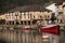 Close-up of an anchored wooden boatOverview of the Port of Orio and a fishing boat.