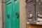 Close-up of Ancient Green Wooden Door with Iron Knob