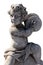 Close up of ancient stone sculpture of naked cherub playing cymbals on white background
