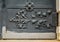 Close-up of ancient vintage metal door with cast iron floral deorative ornament