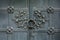 Close-up of ancient vintage metal door with cast iron floral deorative ornament