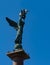 Close-up of an angel with wings holding model of sailboat above it.  Stela Fountain Sea Glory of Russia in Embankment