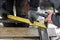 Close up of angle ruler in workers hand, man welding metal with electrodes. Shielded metal arc welding. Tools for workers making