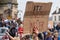 A close up of an anti-racism sign with a crowd of protesters in the background at a Black Lives Matter rally in Richmond, North