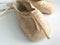Close-up antique ballet slippers worn and well-used on white background. Detail of professional ballet toe shoes