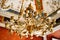 Close-up of an antique gold Italian chandelier. A chandelier-chandelier on gilded chains hangs against the background of