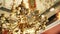 Close-up of an antique gold Italian chandelier. A chandelier-chandelier on gilded chains hangs against the background of