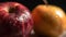 a close up of an apple and an apple with water droplets on it\\\'s skin and a yellow apple in the backg