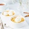 Close up apple crumble with ice cream, spoon with streusel. Side view, vertical. Morning breakfast on a light gray table