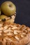 Close-up of apple pie with pippin apples in basket, selective focus, dark background