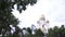 Close up for an apple tree branch with white flowers and the beautiful church behind it. Stock footage. The dome of the