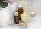 Close up aromatherapy concept with essential oil bottle, bath bomb, burning candles on light background.