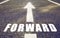 Close up of arrow and word forward on asphalt road