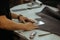 Close up of an artisan working with leather in his laboratory using tools. Handmade concept. Man holding crafting tool