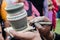 Close-up on artist hands personalizing a clay jug by writing the name of a person.