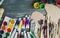 Close up of artist paint brushes, palette and watercolors on grunge gray wooden background.