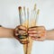 Close Up of an artist/painter hands holding paint brushes