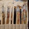 Close up of artists paint brushes in canvas holder