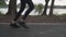 Close up asian athlete woman legs in black sportswear running on asphalt road in urban city trees lake park during sunset.female j