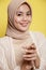 close up asian beautiful hijab female holding hand smile expression very happy