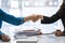 Close up Asian business woman shaking hands with friends in office, collaborative teamwork