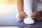 Close up asian child girl tying on feet pointe shoes