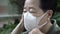 Close up Asian Chinese elderly wearing peotection mask with worry expression for virus spread