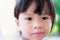 Close Up Asian kid face smile a little bit. Girl has a bangs hairstyle. Child aged 3-4 years old