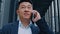 Close up Asian Korean 40s adult mature leader worker investor entrepreneur businessman salesman man talking mobile phone