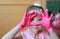 Close-up asian little ballerina girl in a pink tutu expression triangle hands on eyes