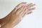 Close up of an Asian teen washing hands with soap after reaching home.