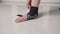 Close up asian woman apply ankle bandage support leg pain. demonstration of wearing ankle support equipment.