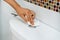 Close up of Asian woman hand using white toilet paper flush toilet to prevent direct contact and prevent infection, virus,