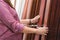 Close up of Asian woman hands looking choose at different type of skirting floor board for decorate her room at construction store