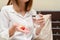 Close up Asian woman holding pill and a glass of water