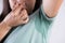 Close-up asian woman with hyperhidrosis sweating. Young asia woman with sweat stain on her clothes against grey background.