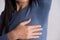 Close-up asian woman with hyperhidrosis sweating. Young asia woman with sweat stain on her clothes against grey background.