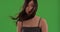 Close up of asian woman\'s face with hair blowing on green chroma key