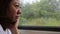 Close Up of Asian Woman\'s Face On A Train, Smiling At The View