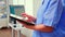 Close up of assistant holding tablet and analysing teeth x-ray