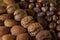 Close up of assortment nuts on a wooden table: wallnuts, almonds