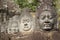 Close up of Asuras demons statues in a row at the Bayon Temple entrance gate