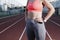 Close-up of an athlete`s torso on an athletics track