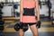 Close up of athletic girl making exercise with dumbbells in gym.