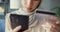 Close-up Attractive cheerful young Asian islam muslim beauty girl in hijab with casual sitting on couch use phone enjoy successful