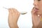 Close Up of an Attractive Natural Young Woman Holding a Spoonful of Salt