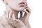 Close up of attractive young woman gently touching her face with white background - cosmetic, wellness, manicure